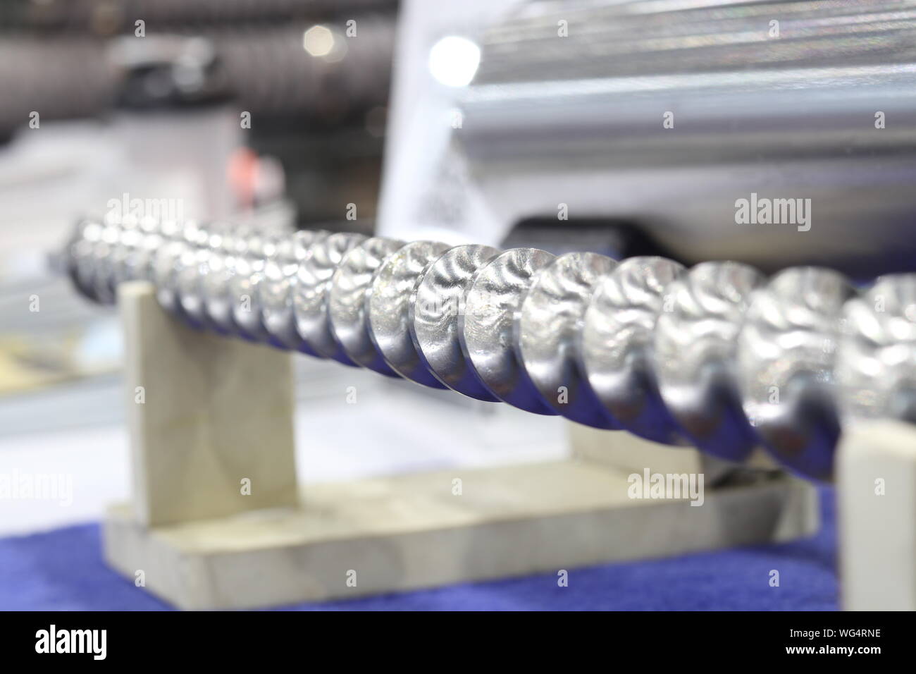 Screw press parts for plastic injection machine ; selective focus Stock Photo