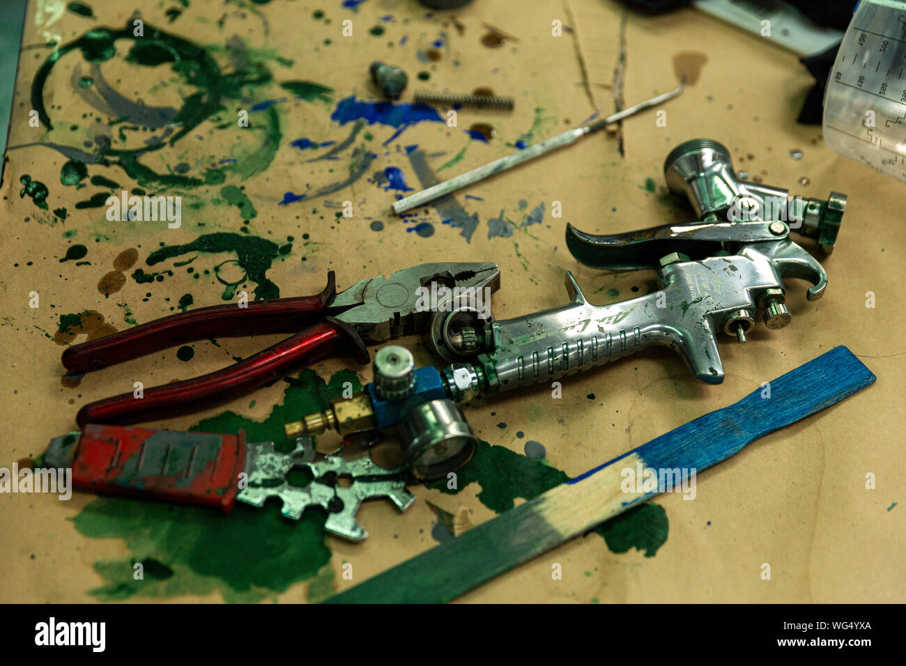 Professional Spray Painting Equipment Placed On Work Bench Stock