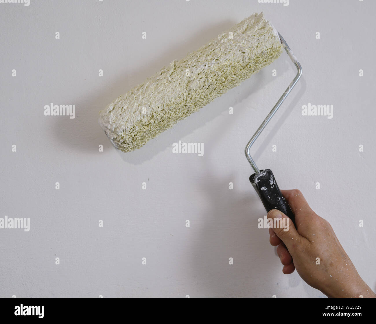 Authentic Photo Of Aged Woman Painting Interior Wall With