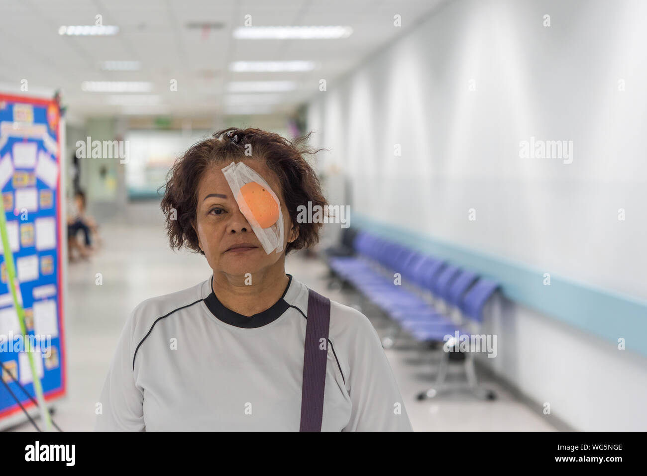 Portrait Of Senior Woman With Medical Eye Patch Standing At Hospital Stock Photo