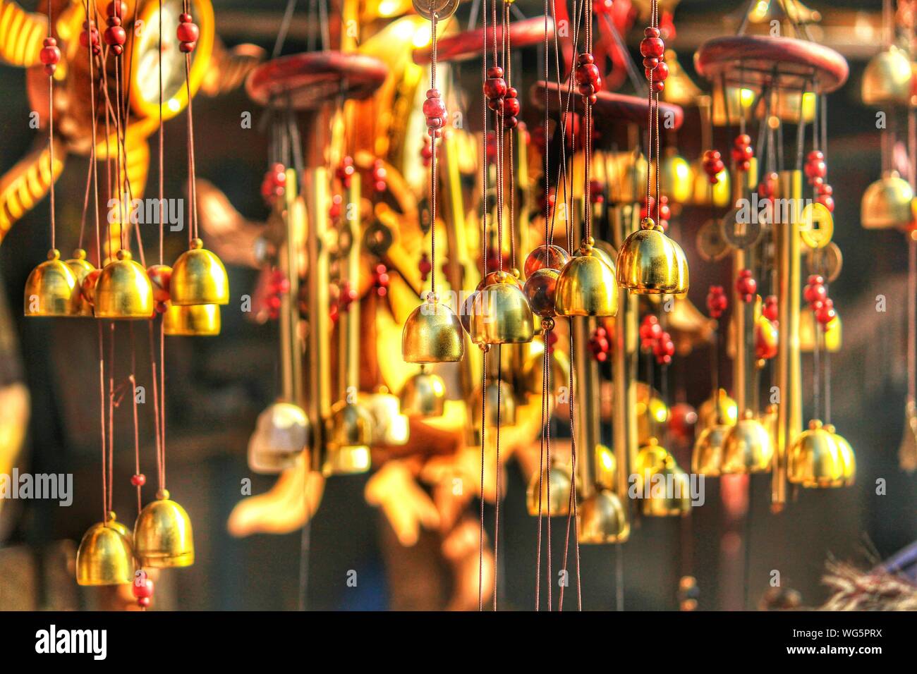 Close-up Of Wind Chimes Hanging For Sale At Market Stock Photo