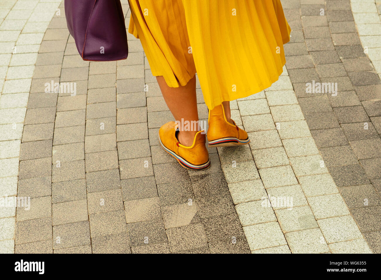 Low Section Of Mature Women Walking On Pavement Stock Photo