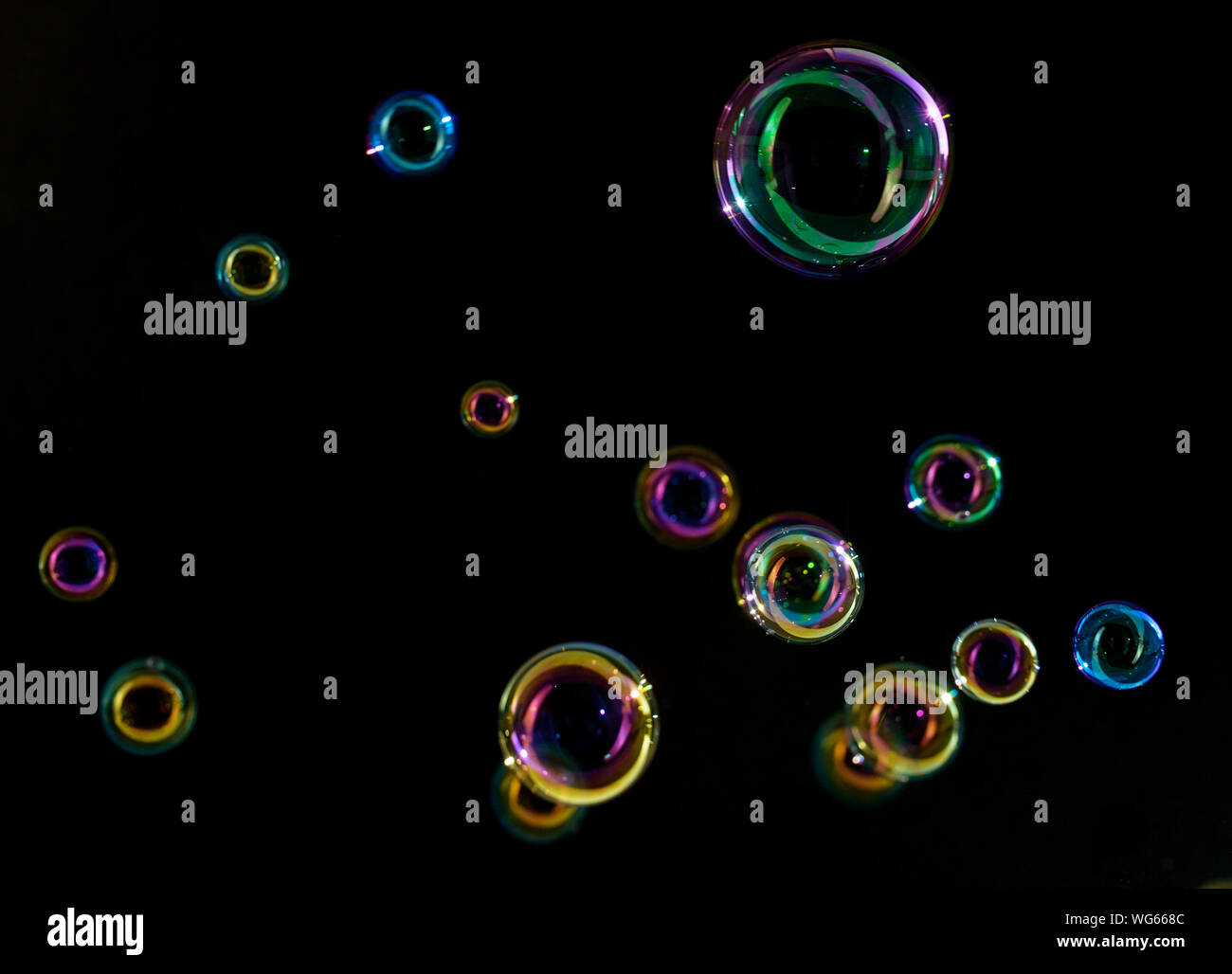 Soap bubbles on a dark background in motion. Stock Photo