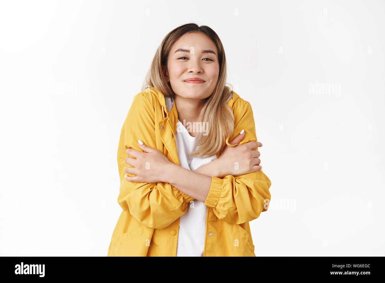 Girl warming up put on yellow jacket 