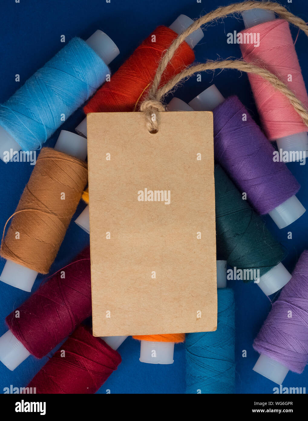 Close-up Of Blank Label With Colorful Spools Stock Photo
