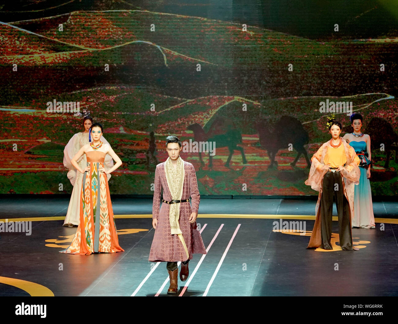 Dunhuang, China's Gansu Province. 31st Aug, 2019. Models present creations during a performance held in Dunhuang, northwest China's Gansu Province, Aug. 31, 2019. A performance featuring music and dances and fashion shows presenting unique patterns of Dunhuang murals and China's ethnic groups is held at Dunhuang Grand Theater on Saturday. Credit: Chen Jianli/Xinhua/Alamy Live News Stock Photo