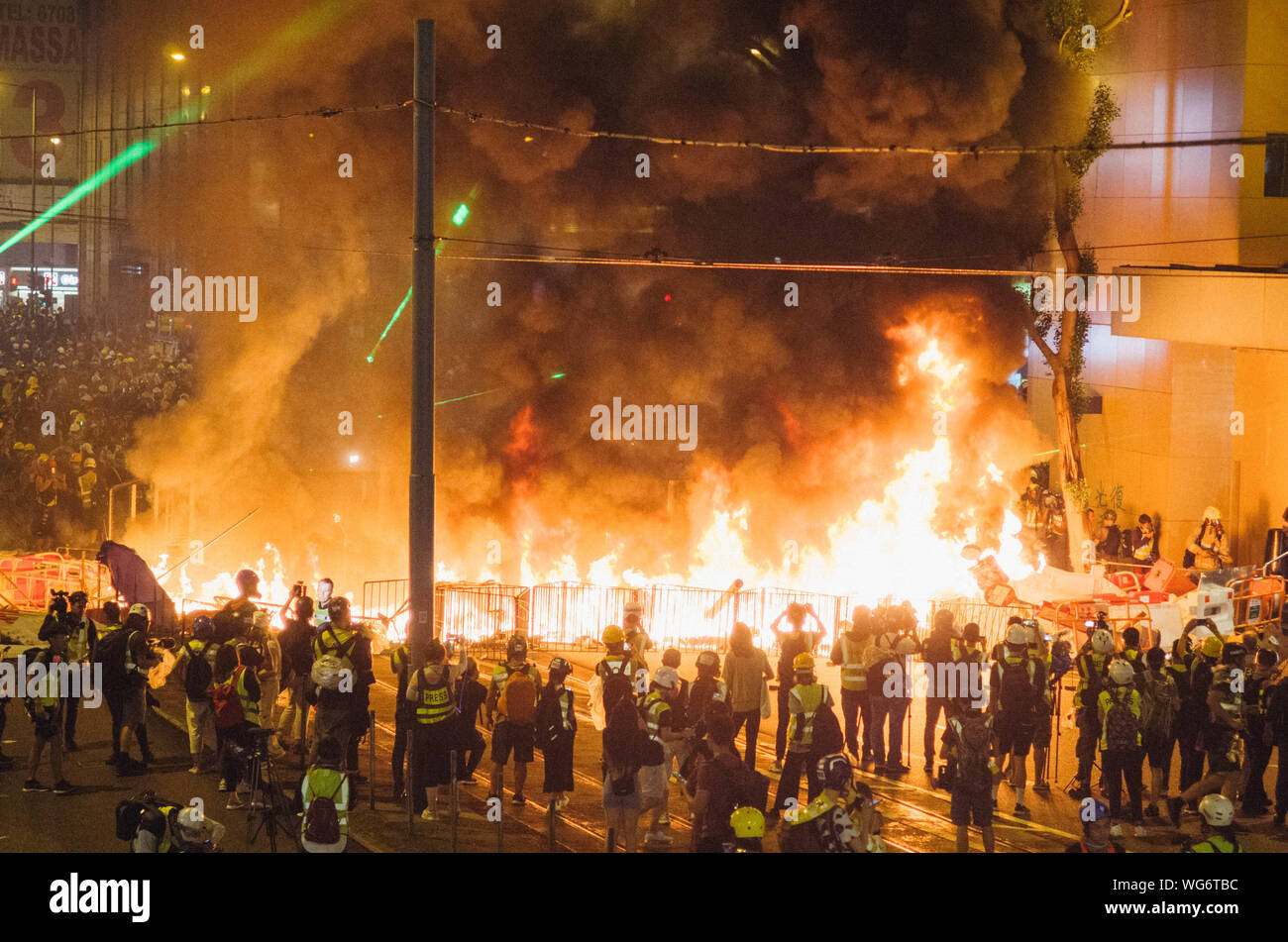 Hong Kong, 31 Aug 2019 - Hong Kong protesters as black bloc that built barricades and set up a fire. Stock Photo