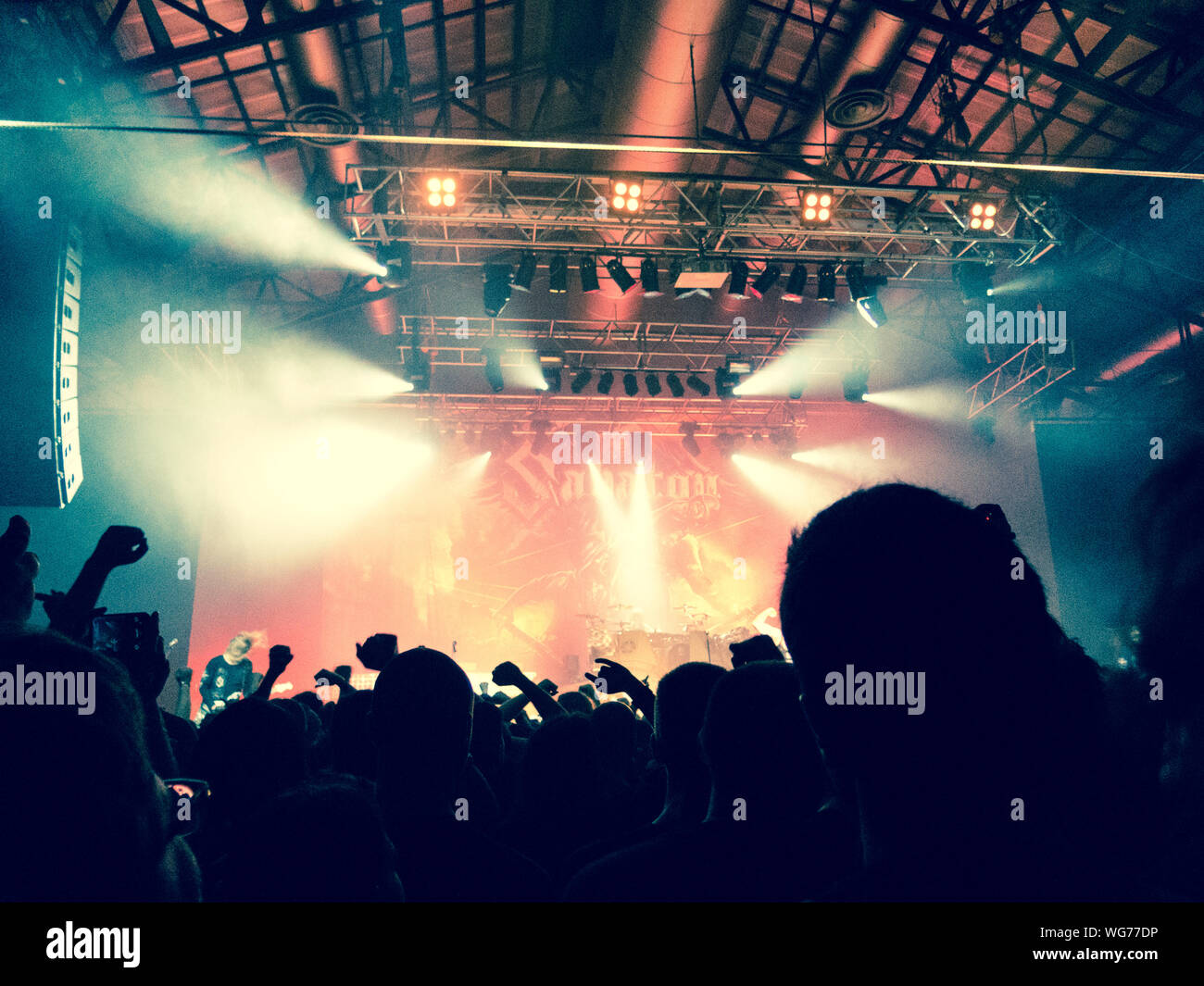 Concert crowd clapping in front of a bright stage Stock Photo Alamy