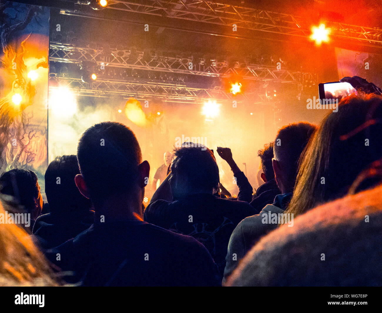 Concert crowd clapping in front of a bright stage Stock Photo Alamy