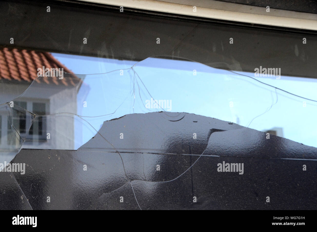 Thermal fracture in a shop window, due to coverage with black plastic foil that has caused overheating of the glas. Vandalism would have shown impact Stock Photo