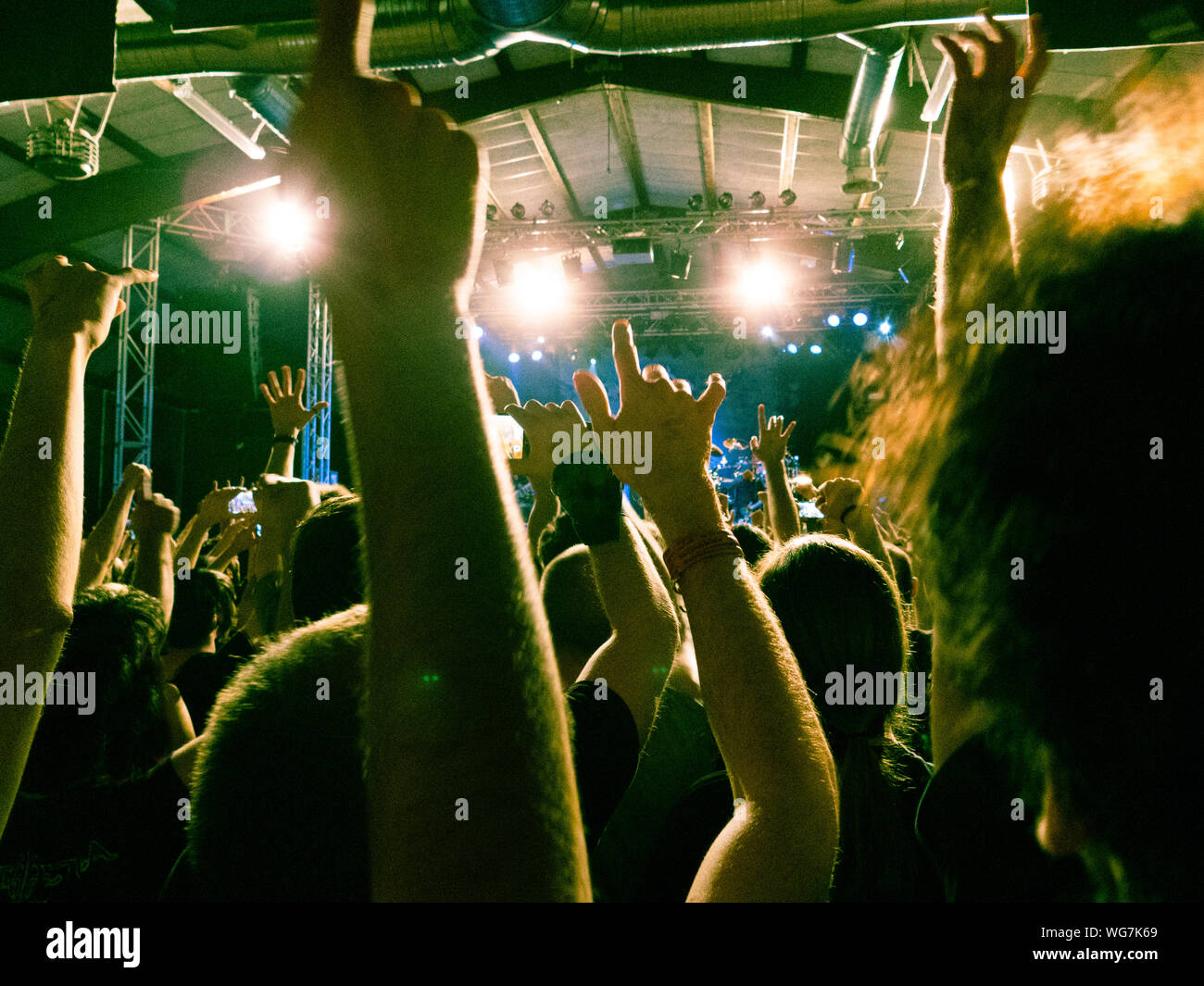 Concert crowd clapping in front of a bright stage Stock Photo Alamy