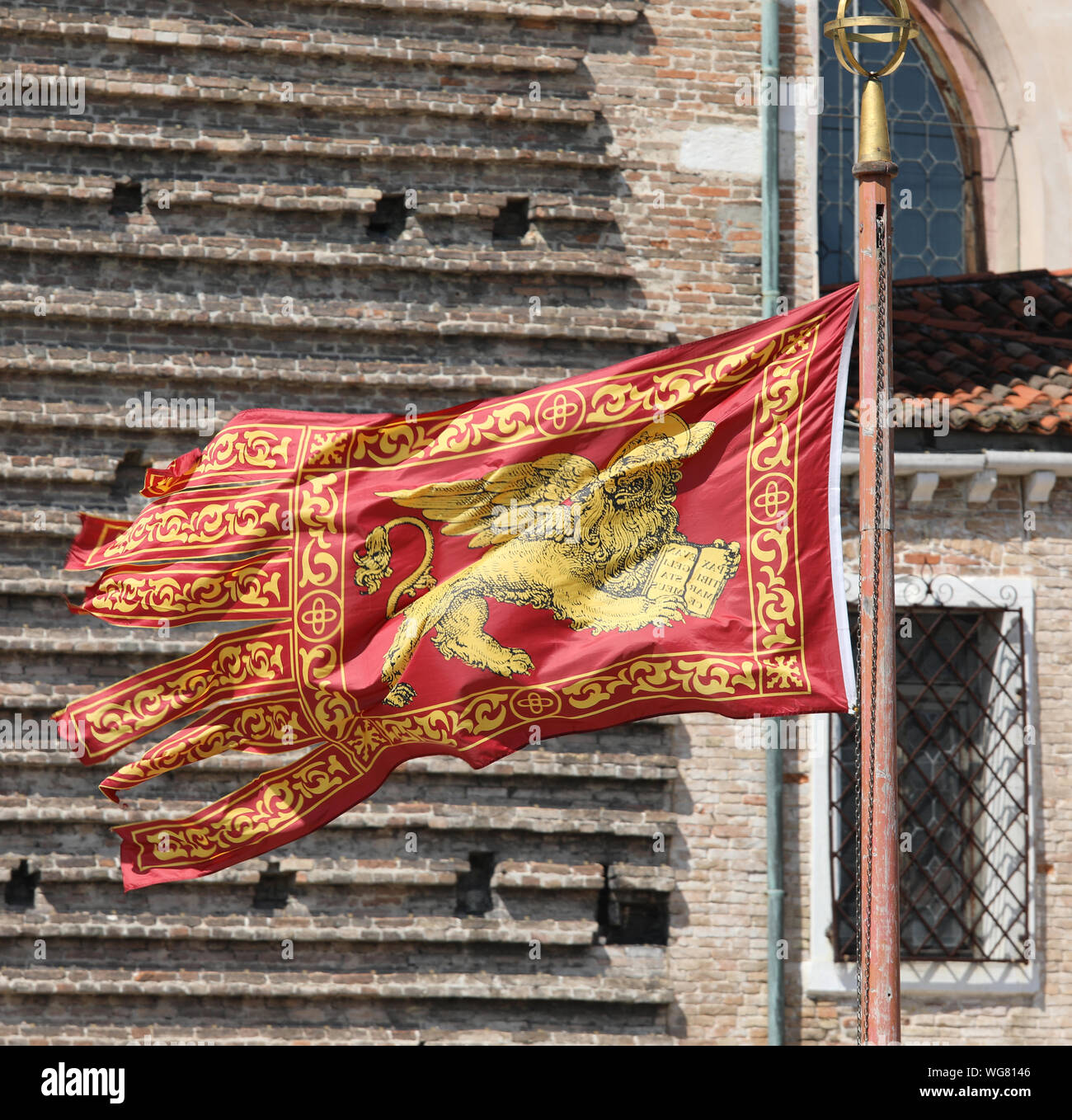 Golden Winged Lion on the Red Flag is the symbol of Serenissima Repubblica in Venice in Italy Stock Photo