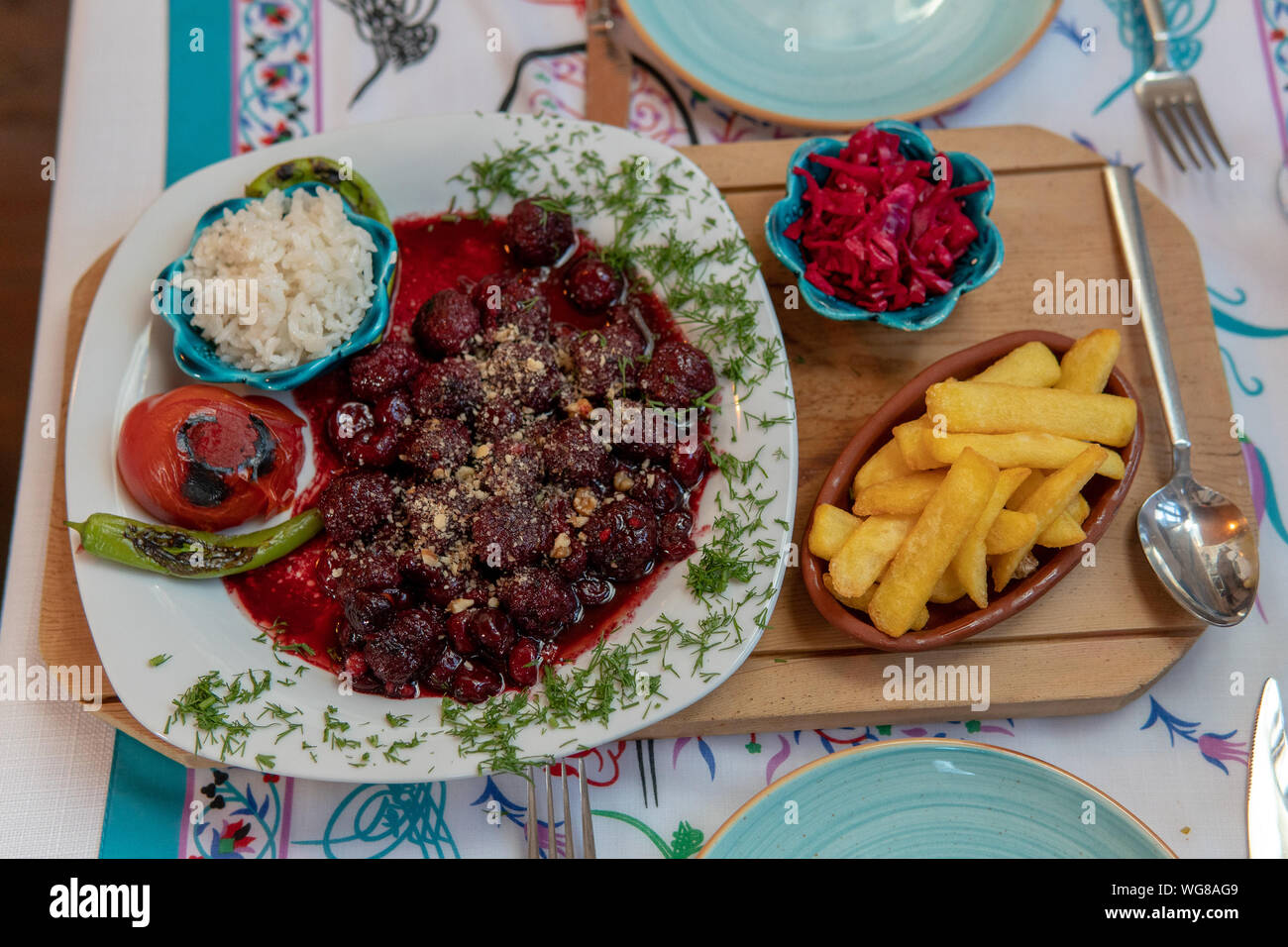 Meatballs in Sour Cherry Sauce (Kabab Karaz) with french fries and coleslaws Stock Photo