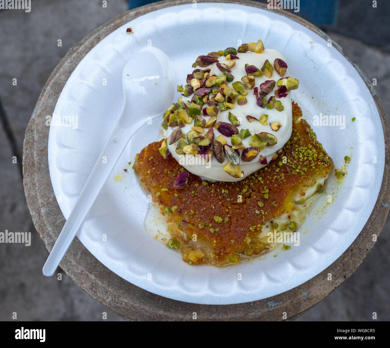 Arabic dessert Kunafa made with cheese and honey and pistache with ice