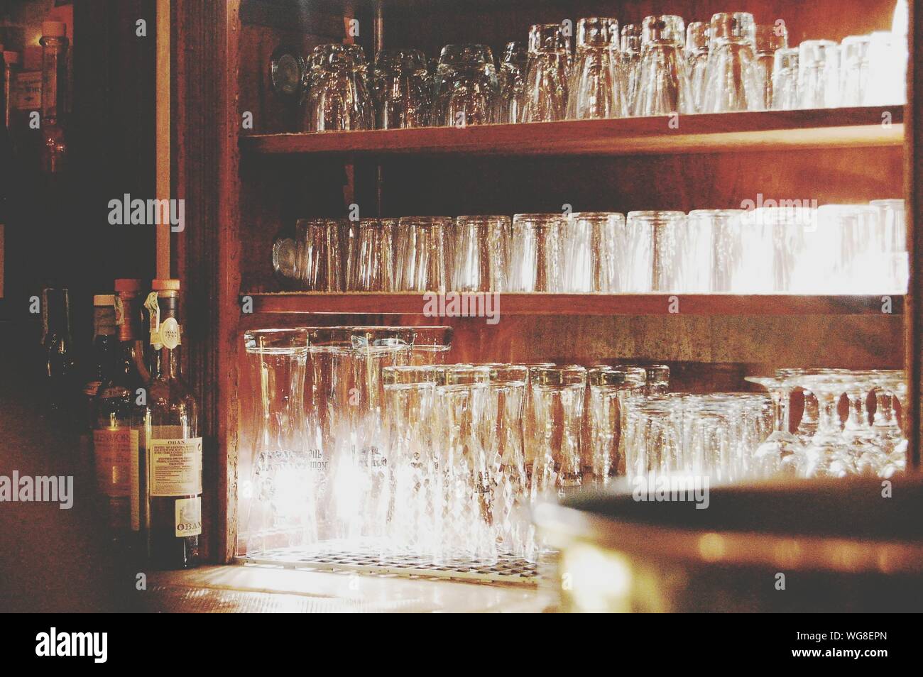 Drinking Glasses Arranged On Rack At Bar Stock Photo Alamy