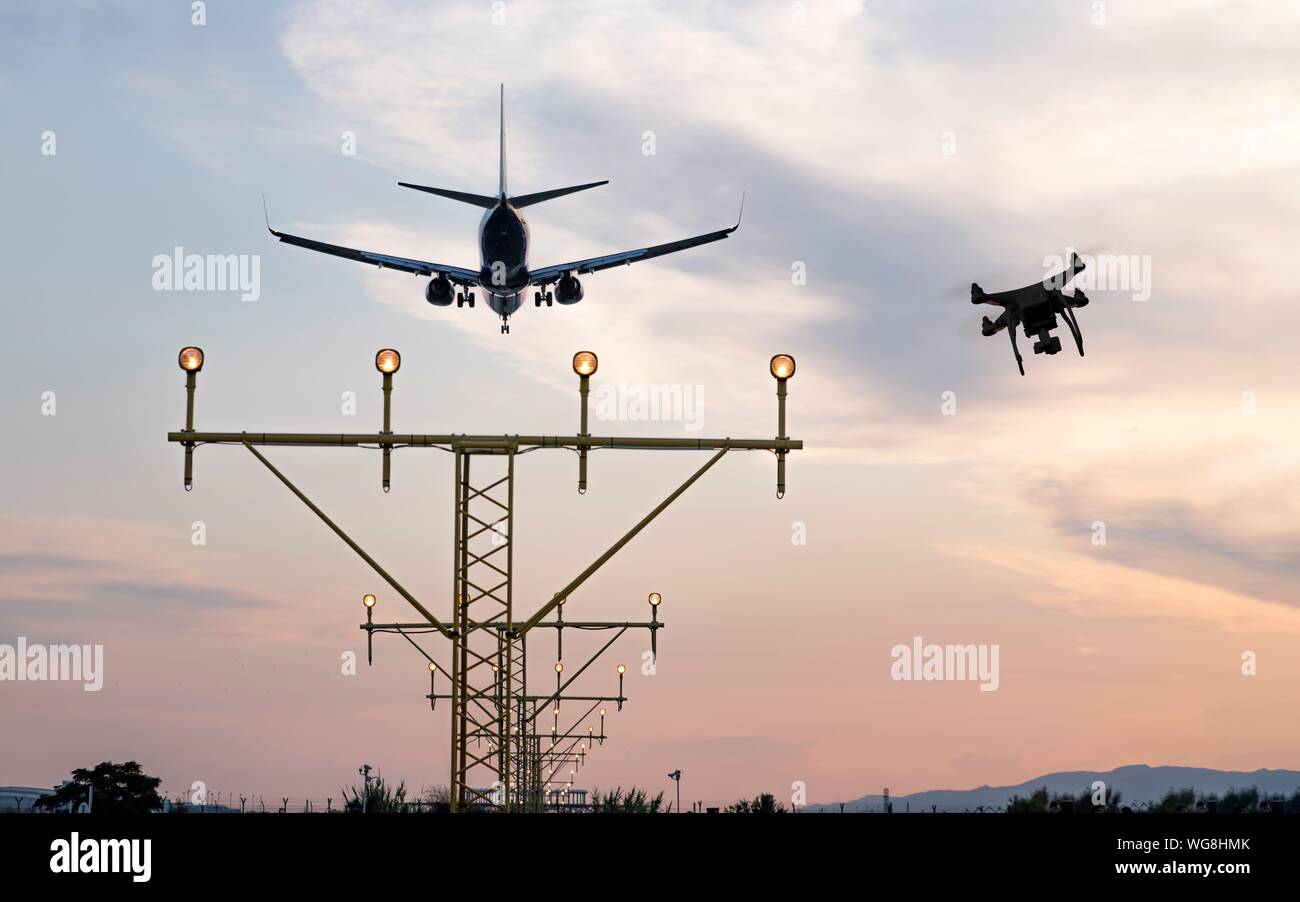 Drone flying at the airport near an aircraft leading to a possible crash or accident. Illegal UAV flight inside the airport conceptual montage Stock Photo