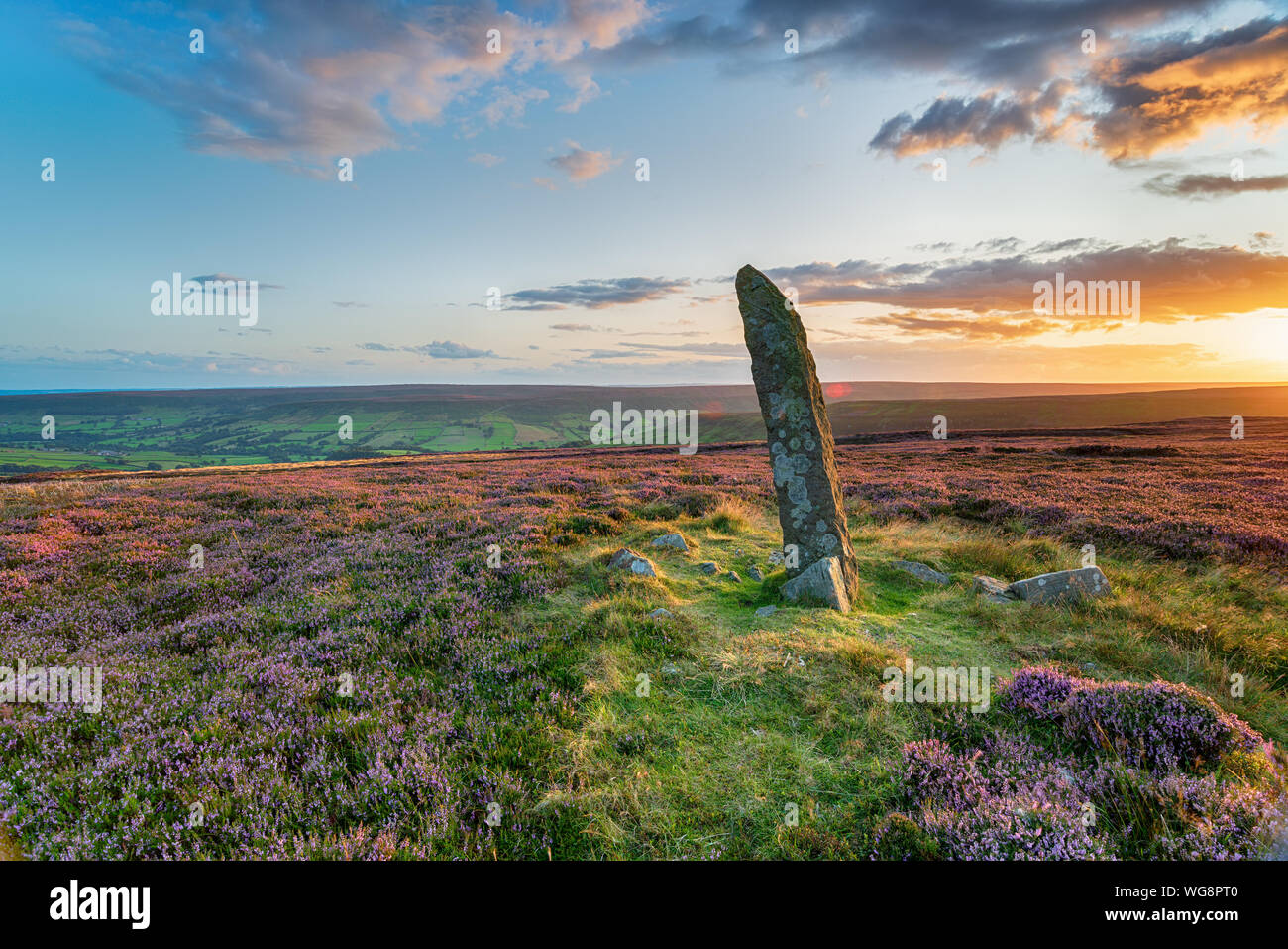 Sunset at Little Blakey Howe, a bronze age round barrow topped with an ancient standing stone on Blakey Ridge in the heart of the North York Moors Nat Stock Photo