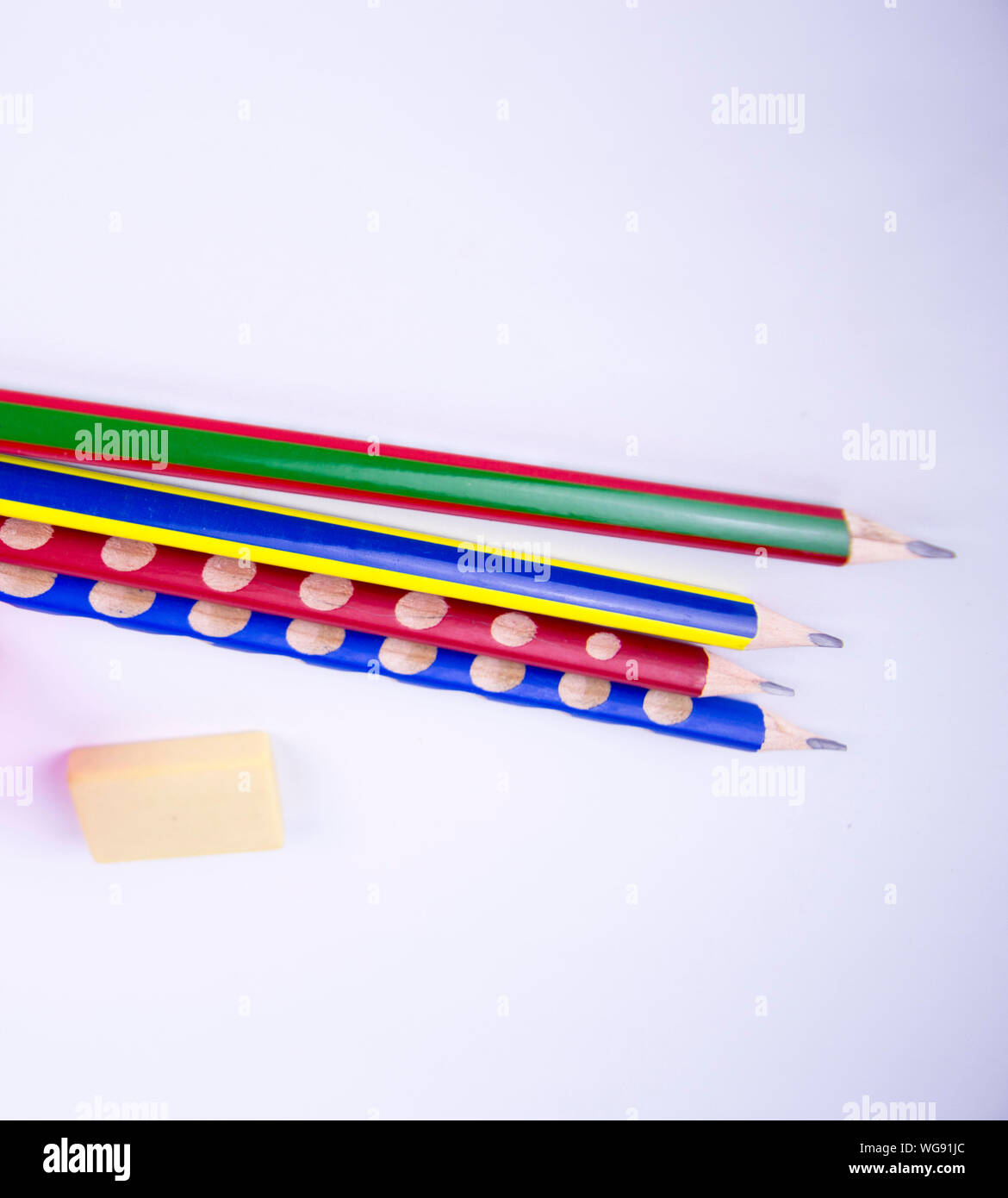 colored pencils with eraser to erase on a white background, there is free  space to fill the text Stock Photo - Alamy