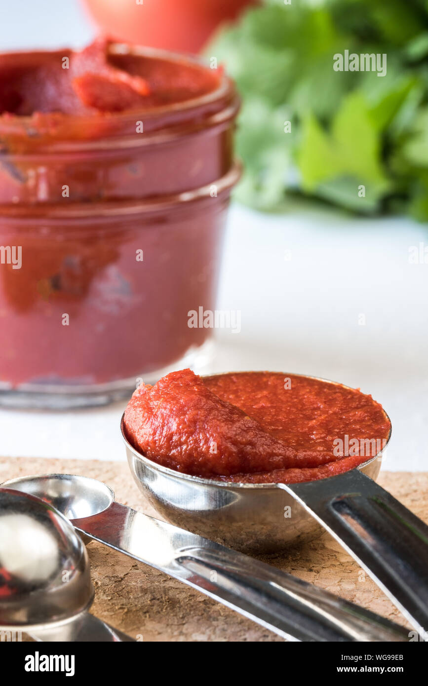 Close-up Of Tomato Paste In Steel Spoon Stock Photo
