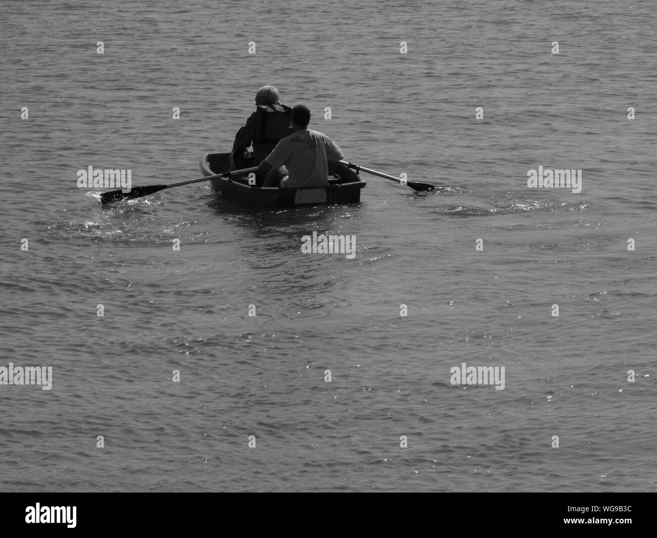 Two men in a boat Black and White Stock Photos & Images - Alamy