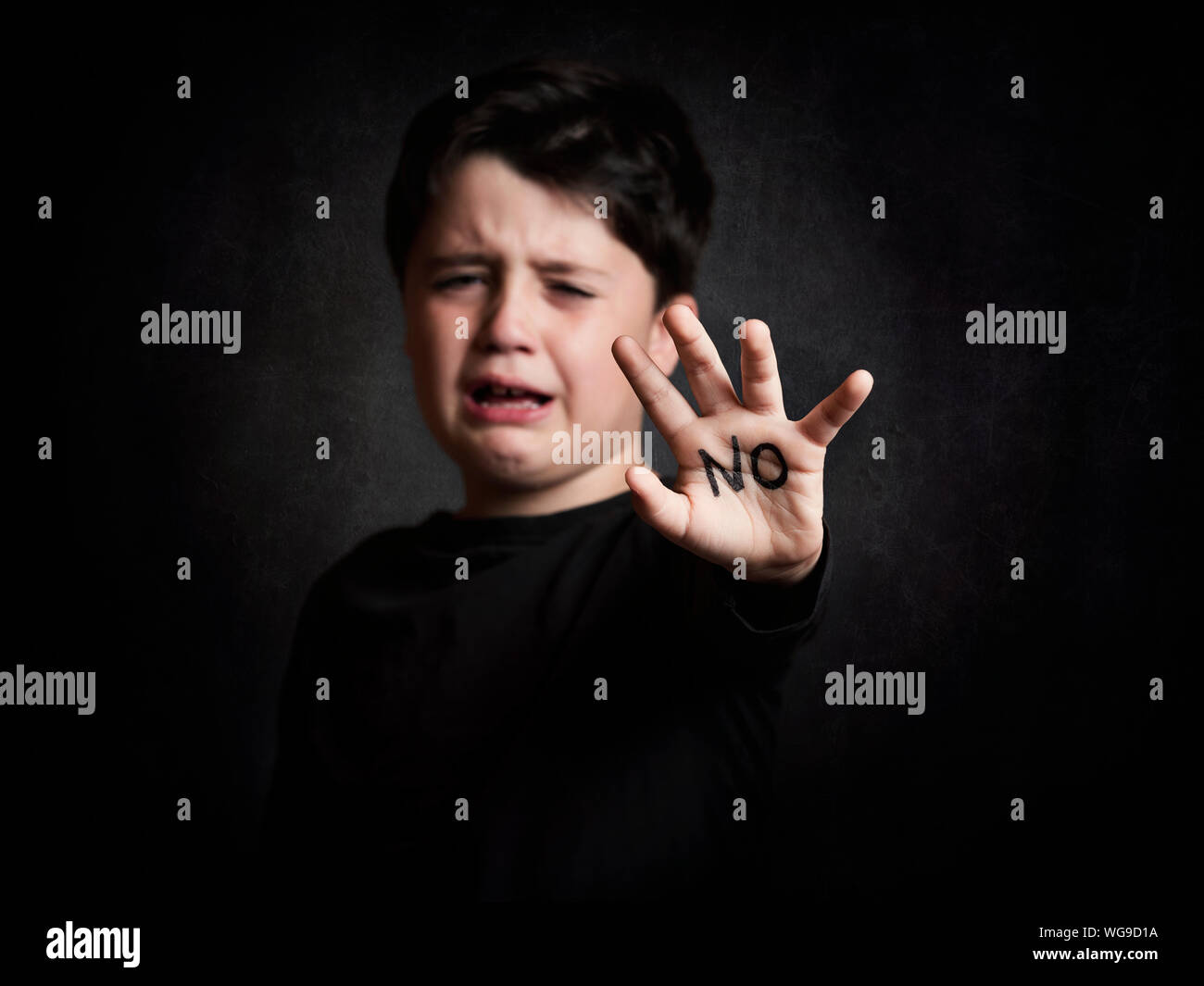 Sad Boy Showing Hand With No Text Against Black Background Stock Photo -  Alamy