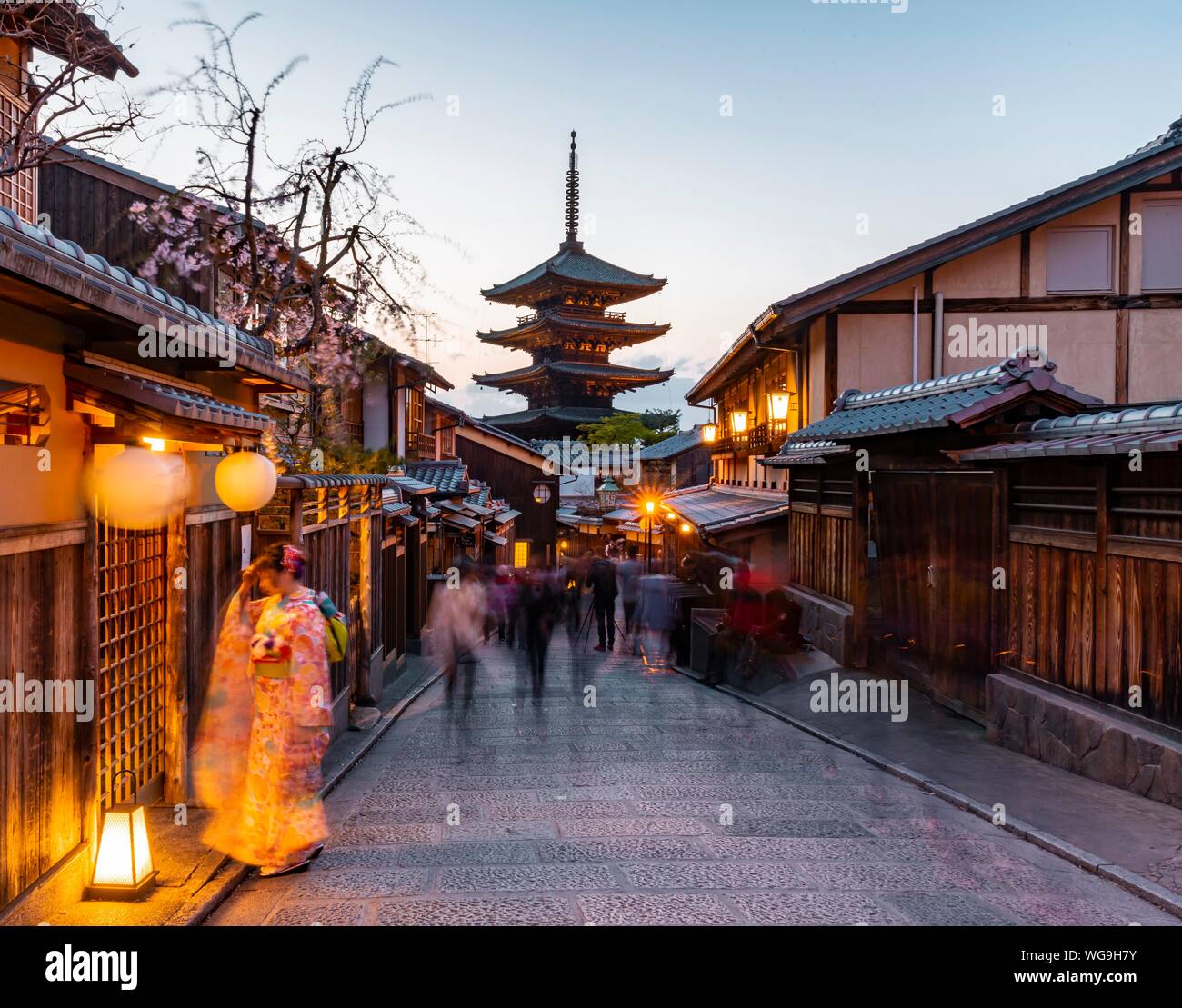 Woman in kimono and pedestrian in an alleyway, Yasaka dori historical alleyway in the old town with traditional Japanese houses, rear five-storey Stock Photo