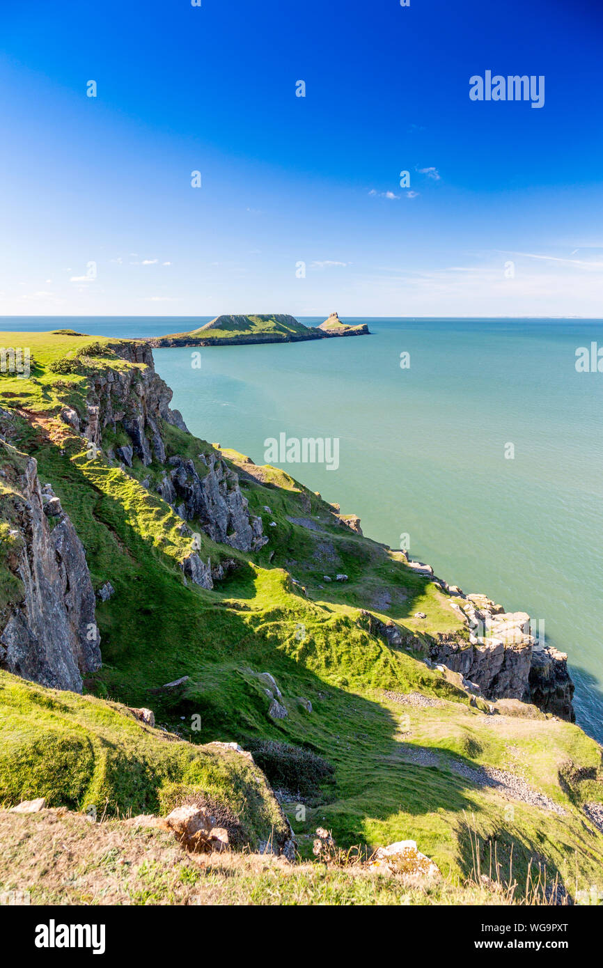 The coastline between Rhossili and Worms Head on the Gower peninsula is composed of steep carboniferous limestone cliffs,  South Wales, UK Stock Photo
