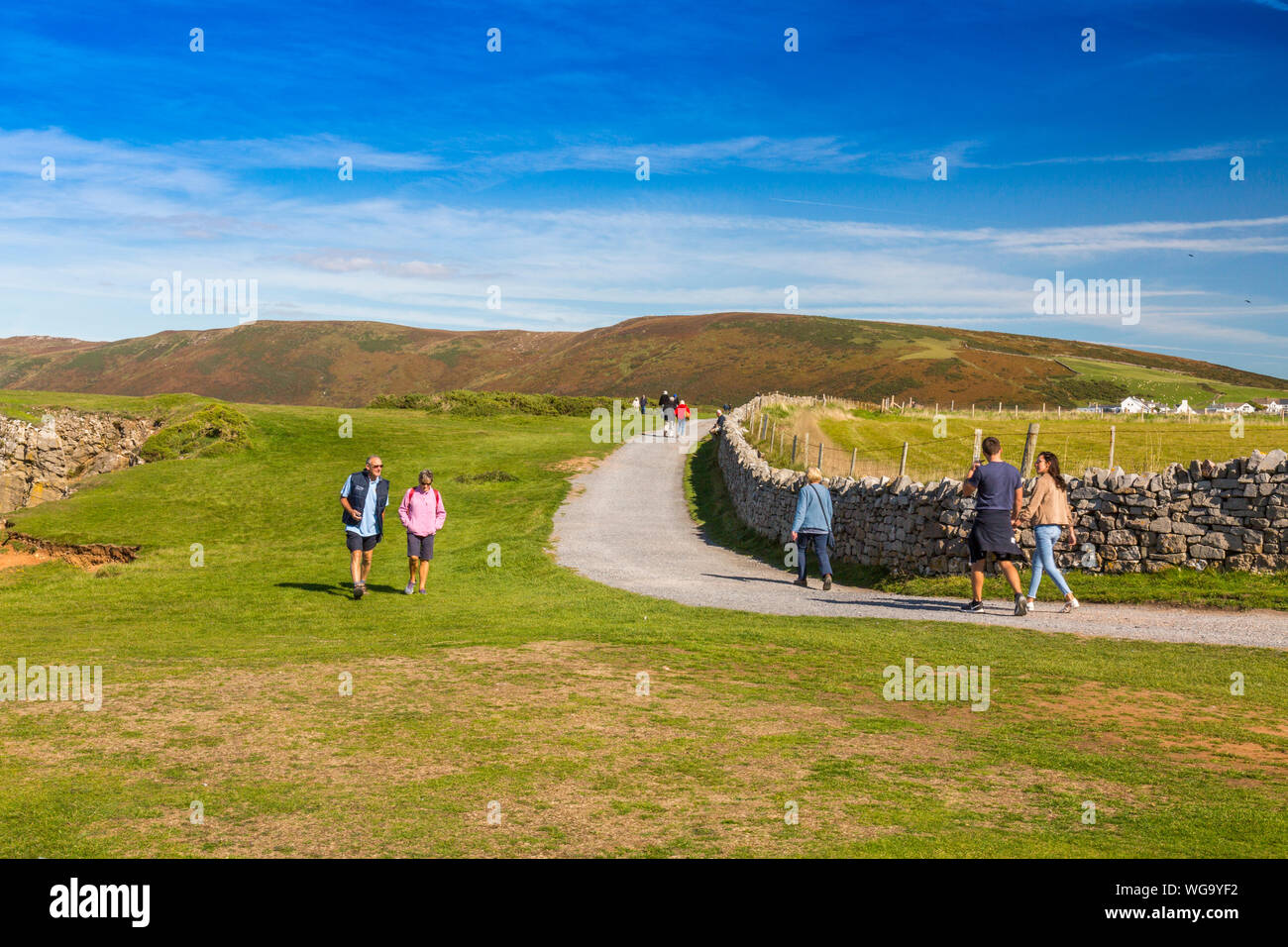 The pathway between Rhossili and Worms Head on the Gower peninsula is a popular route for tourists,  South Wales, UK Stock Photo