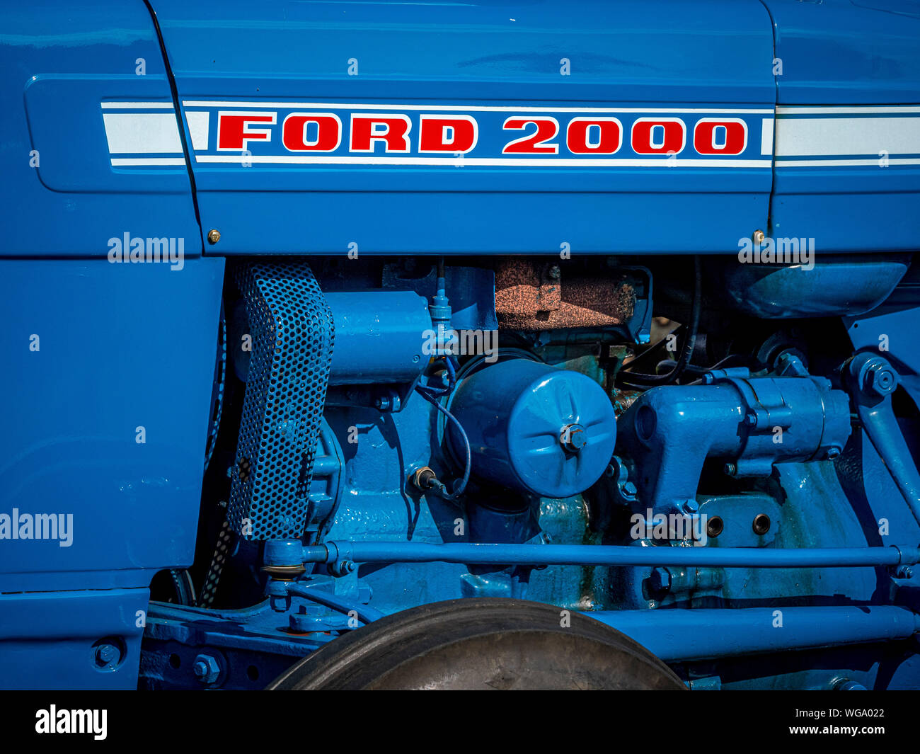 Engine of Ford 2000 vintage tractor painted blue with red and white lettering Stock Photo