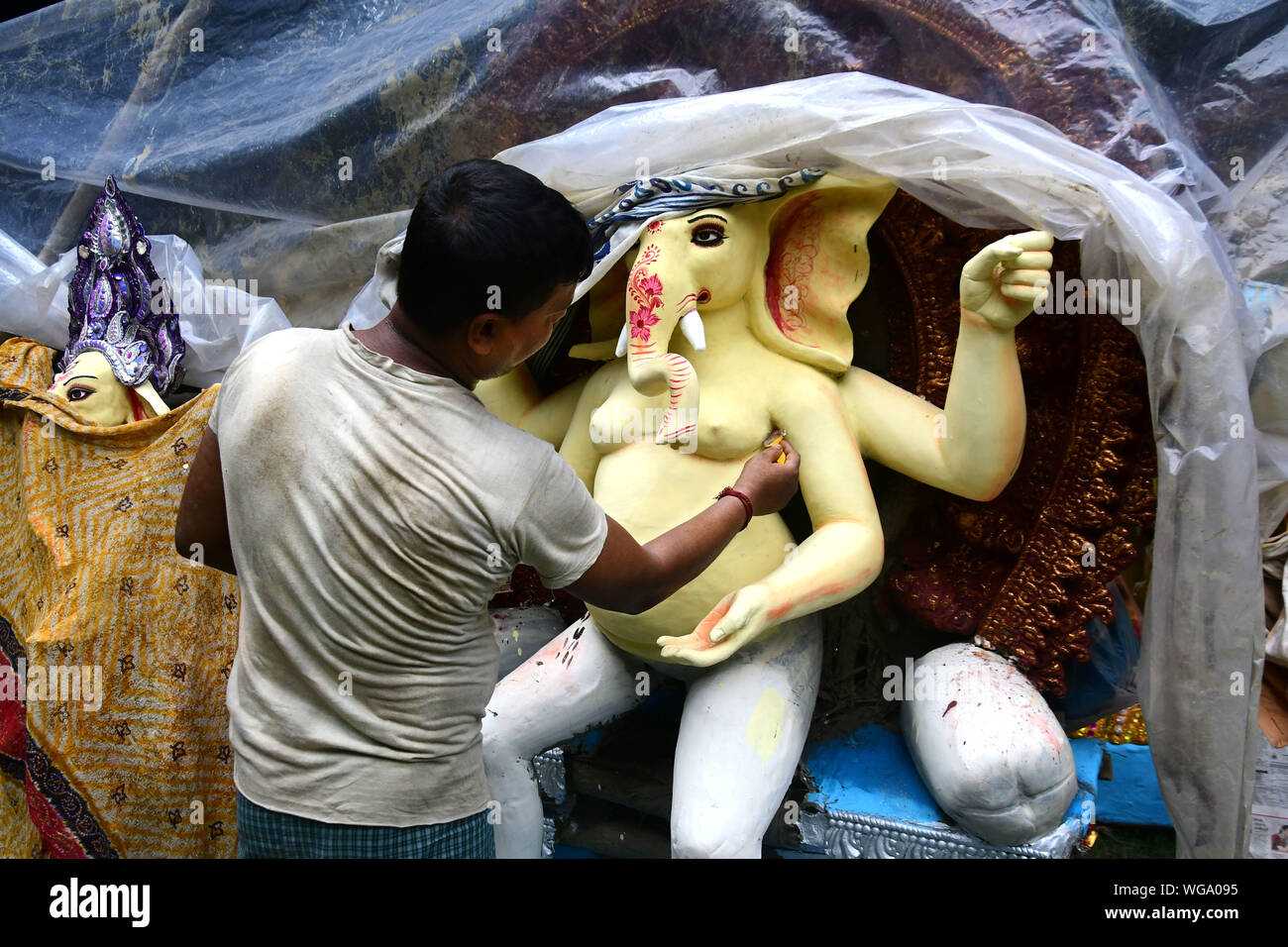 Idol of Lord Ganesha . Artisans of kumortuli , kolkata makes thousands of lord ganesha clay idols every year. Stock Photo
