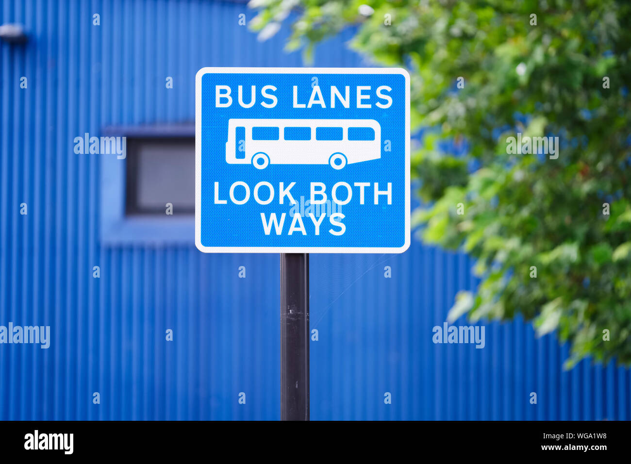 Bus lanes sign in city with look both ways warning Stock Photo