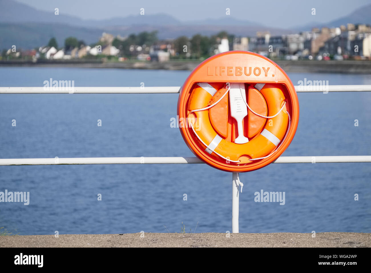 Lifebuoy orange water safety ring at Helensburgh beach Stock Photo