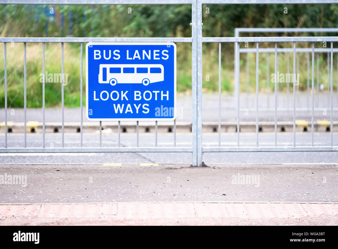Bus lanes sign in city with look both ways warning Stock Photo