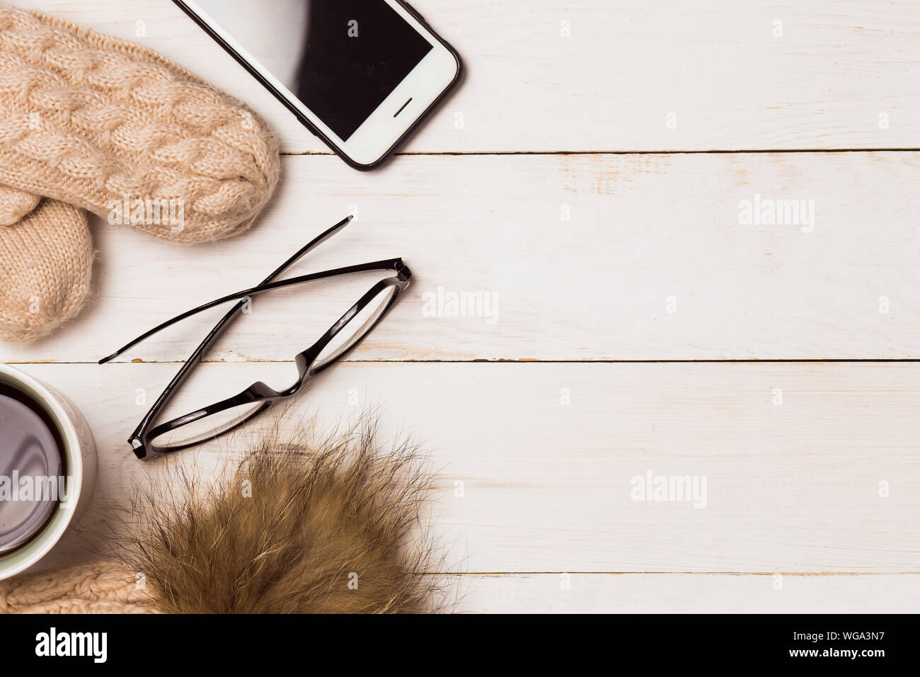 Flat Lay With Winter Warm Clothes Knitted Hat With Mittens Coffee Glasses And Smartphone On Wooden White Background With Copy Space Christmas Conc Stock Photo Alamy