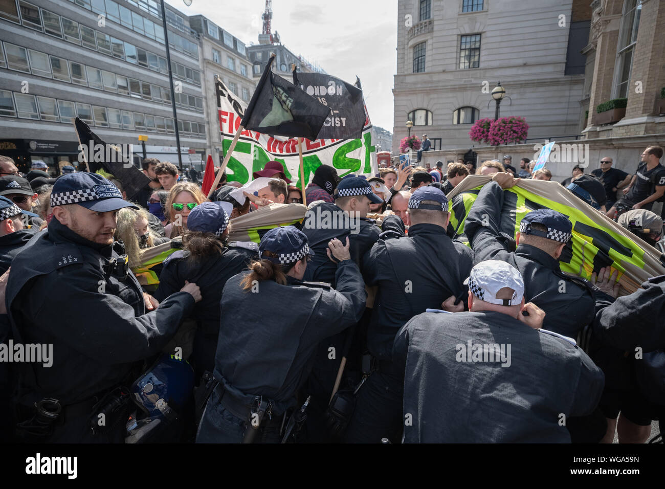 'Free Tommy Robinson' counter-protesters including antifascist activists oppose the pro-Robinson demonstrators outside BBC Broadcasting House, London. Stock Photo