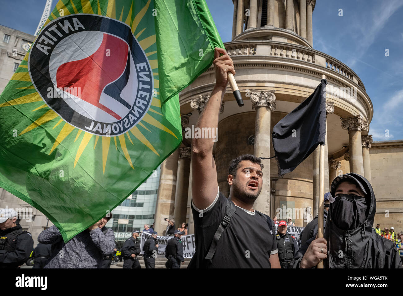 'Free Tommy Robinson' counter-protesters including antifascist activists oppose the pro-Robinson demonstrators outside BBC Broadcasting House, London. Stock Photo