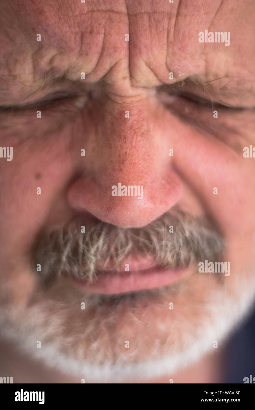 Close-up Of Angry Senior Man Grimacing Stock Photo