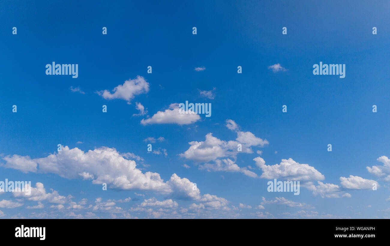 White Fluffy Clouds Floating in the Bright Blue Skies on a Summer Day ...