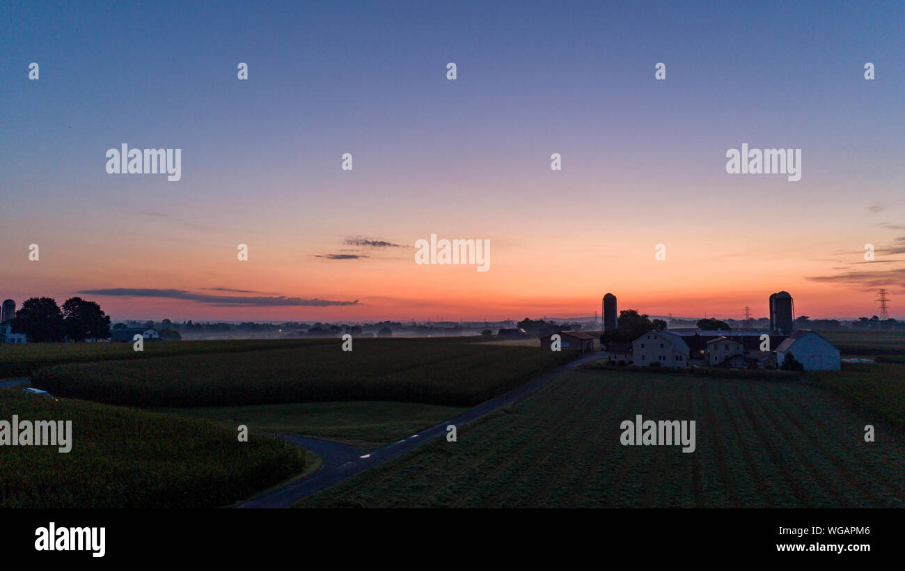 An Aerial View of a Sunrise Over an Amish Farm with Blues and Reds on a ...