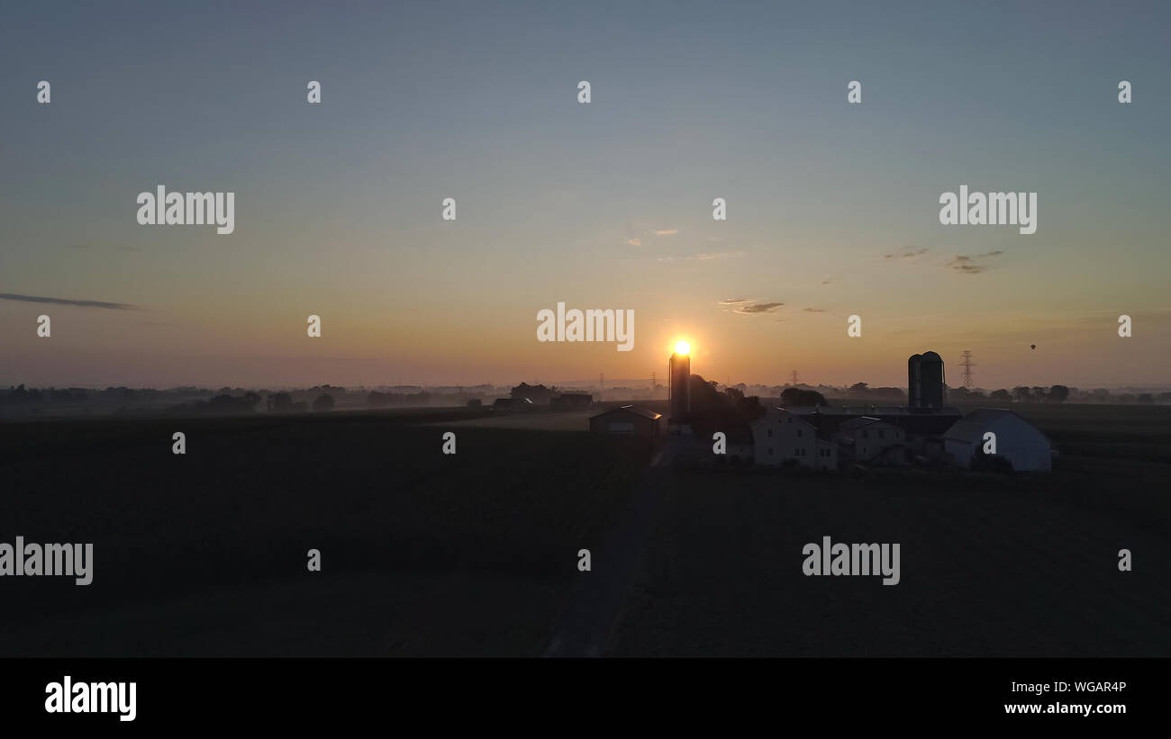 An Aerial View of a Sunrise Over an Amish Farm with Blues and Reds on a ...