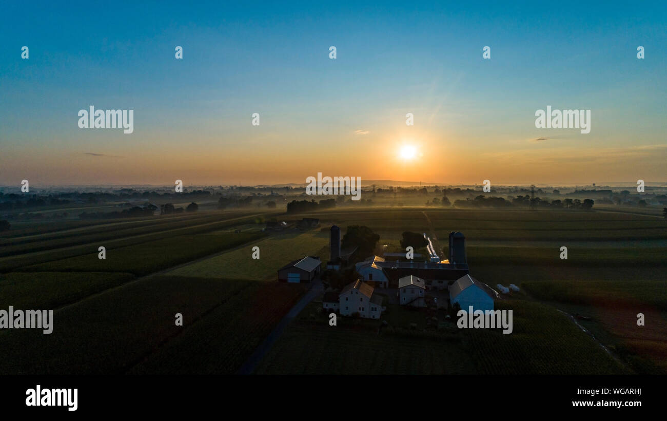 An Aerial View of a Sunrise Over an Amish Farm with Blues and Reds on a ...