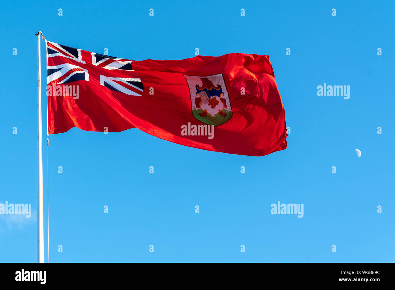 Bermuda Flag on the Blue Sky with Moon Stock Photo
