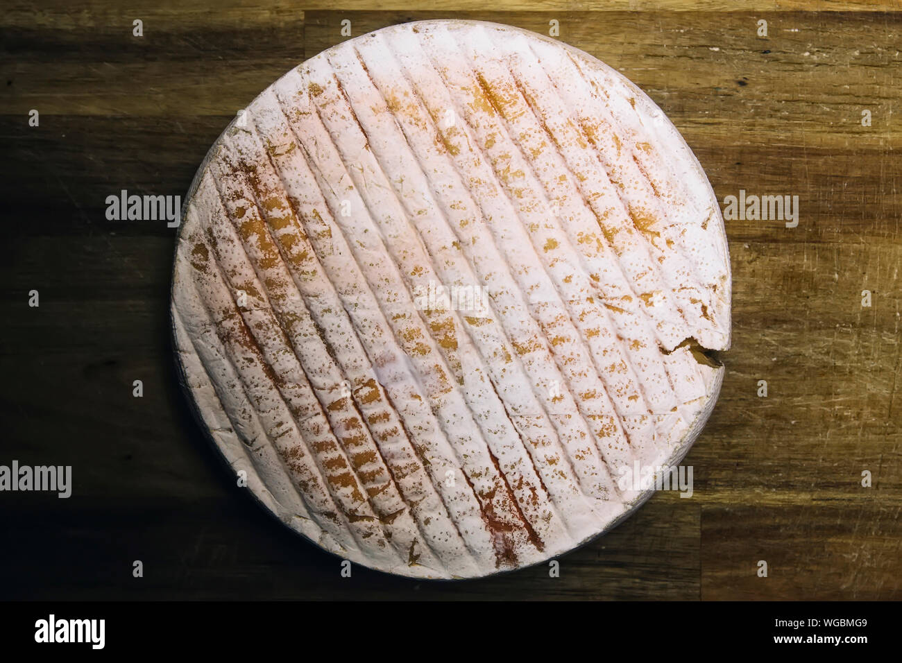 Detail of the French Le Marcaire cheese on the wooden table Stock Photo