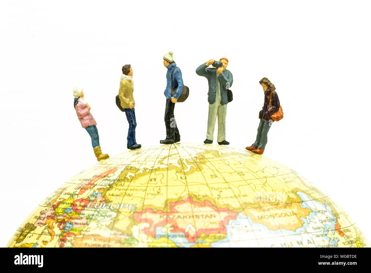 Miniature people travel around the globe close up. Image concept. Stock Photo