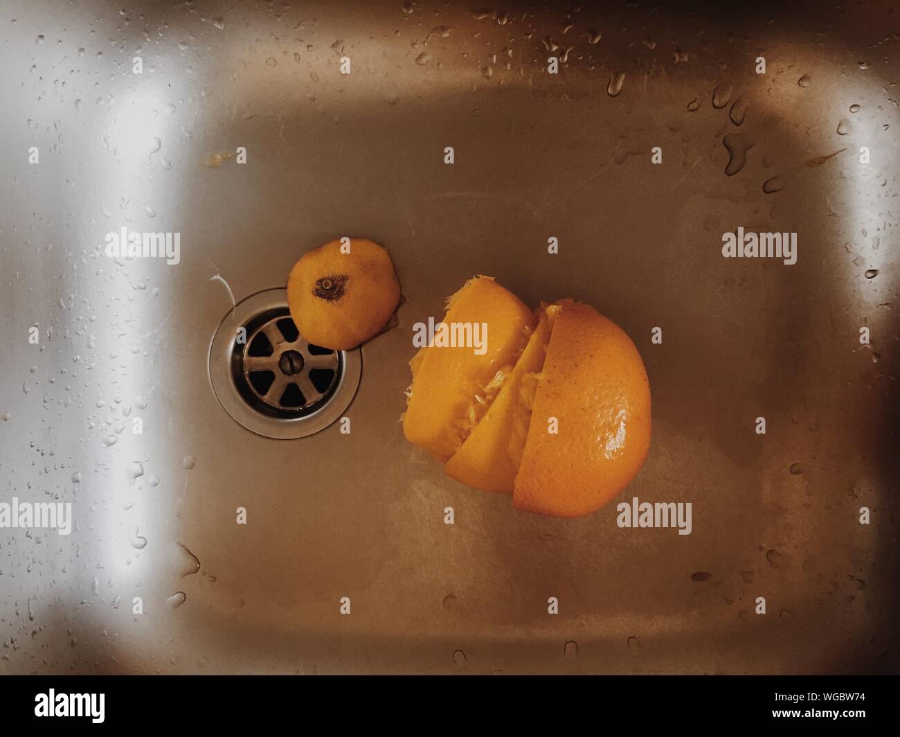 Directly Above Shot Of Orange Peels On Wet Sink Stock Photo Alamy