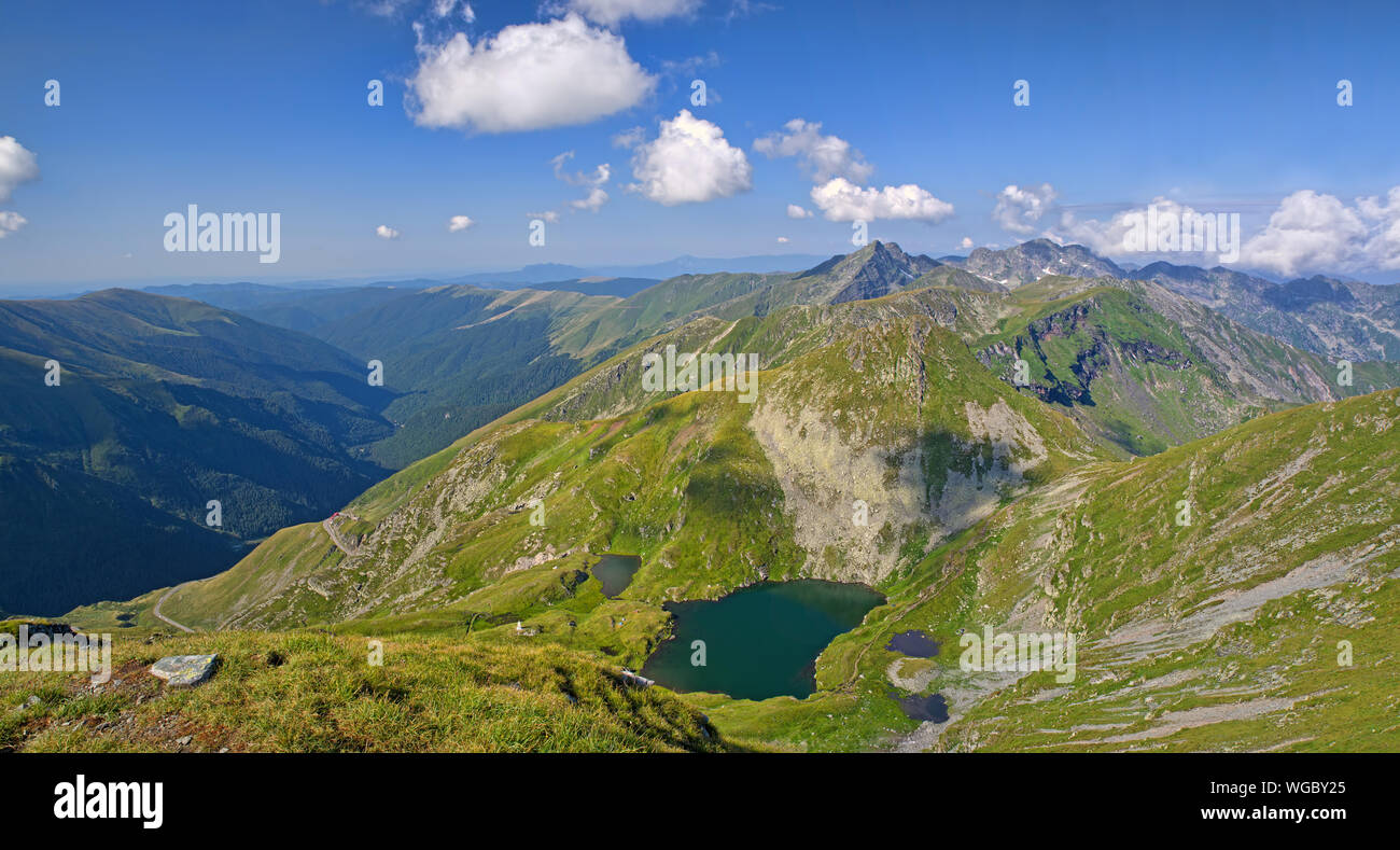Summer alpine mountain scene with glacier lake of Capram Fagaras Mountains in Romania Stock Photo