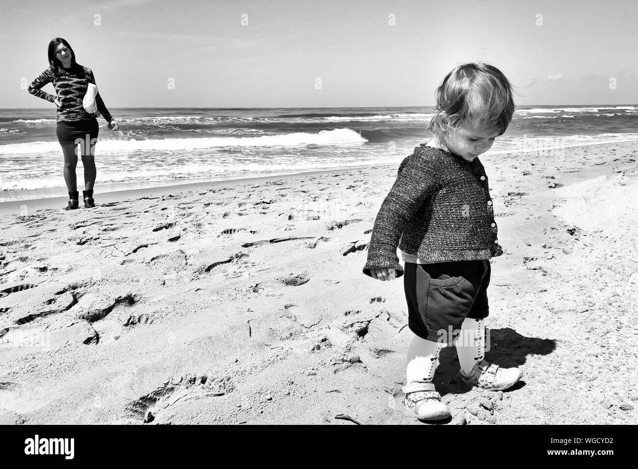 Full Length Of Mother With Baby Girl Standing At Beach Stock Photo Alamy