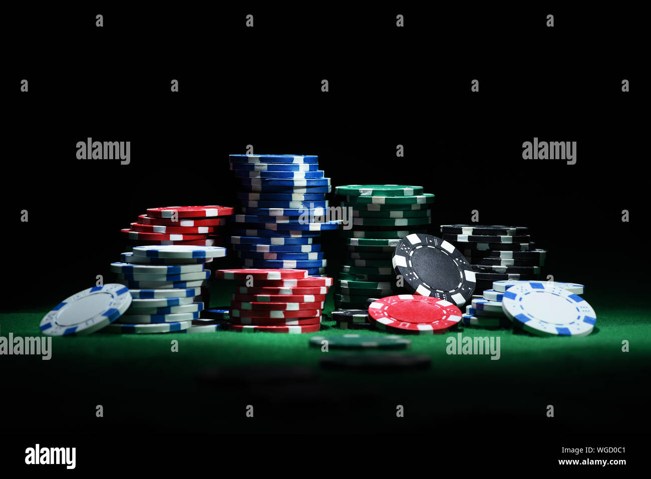Close up shot of group poker chips on green table. Front view Stock Photo