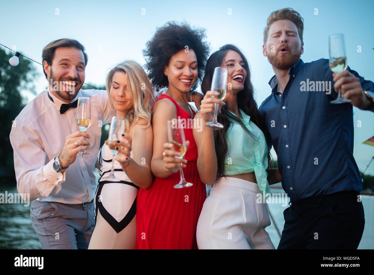 Young friends partying together champagne hi-res stock photography and ...