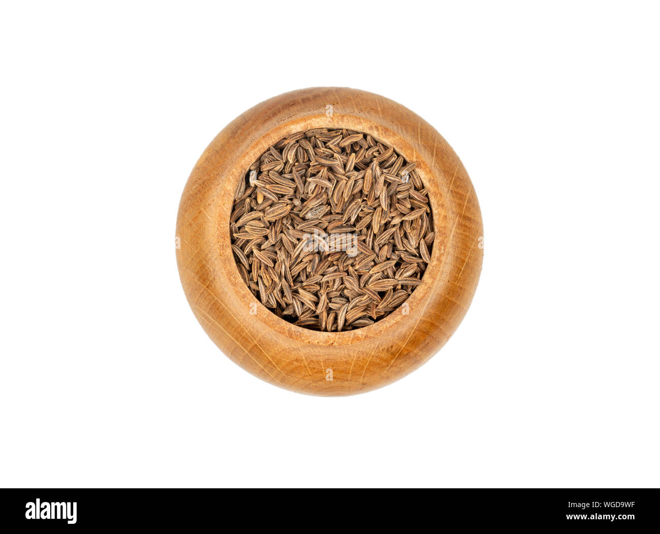 Cumin spice in wooden container isolated on white background, top view